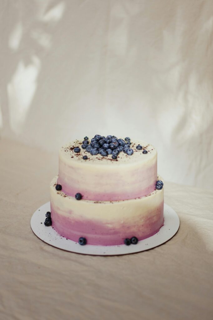 Two-tier blueberry cake with creamy frosting, perfect for celebrations.